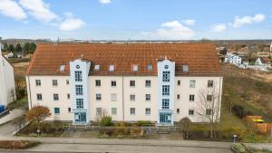 a large white building with a red roof at Top Unterkunft direkt vor Leipzig in Schkeuditz