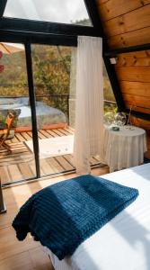 a bedroom with a bed and a large window at Encanto Glamping in Las Dalias