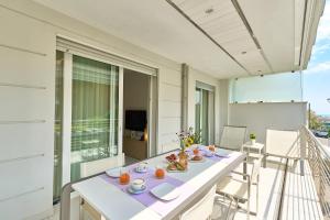 a white table and chairs on a balcony at JUST SUITES in Cervia +5 photos