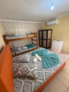 a small bedroom with a bed with at Hotel Leblon in Peruíbe