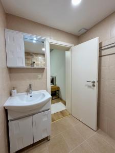 a bathroom with a white sink and a shower at Boutique Rooms Desi 1 in Pleven