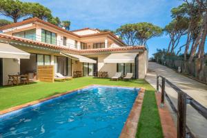 a house with a swimming pool in front of a house at Nou Sol Solet in Begur