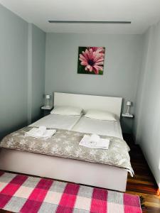 a bedroom with a bed with two towels on it at IANIS Apartment in Orăştie