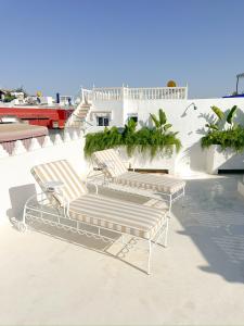 three benches sitting on top of a building at Riad Olivia in Asilah