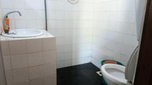 a bathroom with a toilet and a sink at Pelangi Beach Resort in Cherating