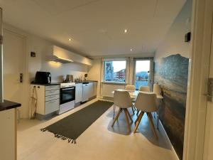 a kitchen with a table and chairs in a room at Uka Guesthouse Downtown in Nuuk
