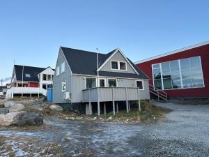 a house is sitting next to a building at Uka Guesthouse Downtown in Nuuk