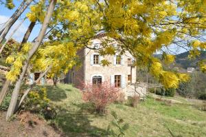an old stone house on a hill with trees at Mas des Druilles in Générargues