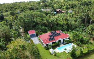 an aerial view of a house with a red roof at Bohol White House Bed & Breakfast in Lila