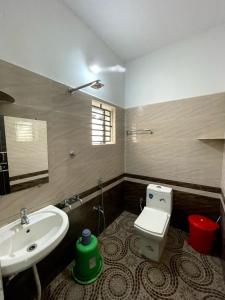 a bathroom with a sink and a toilet at Mango tree room stay in Gokarna +9 photos