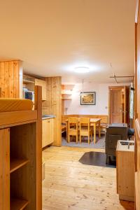 a kitchen and dining room with wooden cabinets and a table at Sruby Peřeje in Ostravice