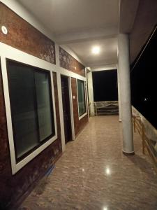 an empty hallway of a building with large windows at Mango tree room stay in Gokarna