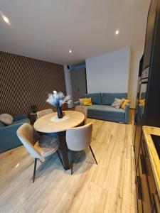 a living room with a table and a couch at Apartament WLK HOUSE in Gdynia