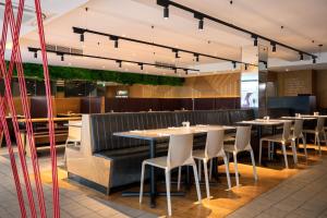 a dining room with tables and chairs in a restaurant at STG Hotel Oxford Street - formerly St Giles London Hotel in London