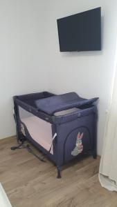 a bed in a room with a blue bed frame at MRȘ House 2 in Bucharest