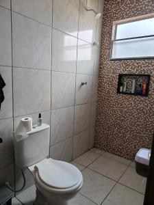 a bathroom with a white toilet and a window at Hostel de clecia in Extremóz +17 photos