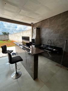 a kitchen with a desk and a chair and a computer at Sobrado Oliveira in Goiânia