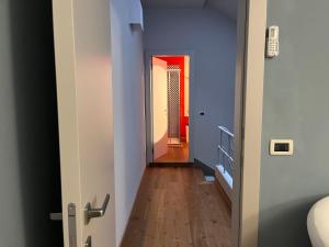 a hallway with blue and white walls and wooden floors at "La Sala di Dante" Wi-Fi, Smart Tv, AC, Bagno Privato in Pistoia