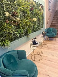 a living room with a wall of plants at Hotel de la Terrasse in Berck-sur-Mer