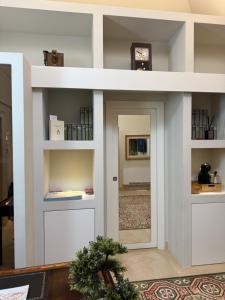 a living room with a white wall with two doors at Bellavitarooms-Fiore di Maggio Luxury Suites in Matera