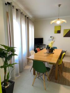a dining room with a wooden table and chairs at BEIRA-MAR, Casinha Sub-Vila in Nazaré
