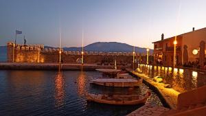 a group of boats in the water next to a building at Rizaki Cottage in Nafpaktos in Nafpaktos