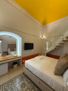 a bedroom with a bed with a staircase and a mirror at Bellavitarooms-Fiore di Maggio Luxury Suites in Matera