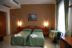 Posteľ alebo postele v izbe v ubytovaní Hotel Dorè