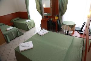 Posteľ alebo postele v izbe v ubytovaní Hotel Dorè