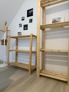 a closet with wooden shelves in a room at Ubytování U Rozárky in Trpnouze