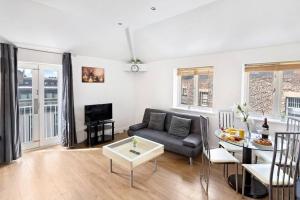 a living room with a couch and a table at Newcastle City Centre Apartment in Newcastle upon Tyne