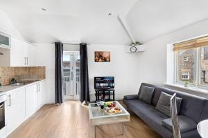 a living room with a couch and a table at Newcastle City Centre Apartment in Newcastle upon Tyne +38 photos