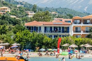 a group of people on a beach in the water at Nefeli in Vasiliki