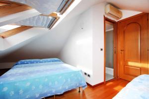 a bedroom with a blue bed in a attic at WI-RO Risorgimento,9 - La Perla di Andora in Marina di Andora