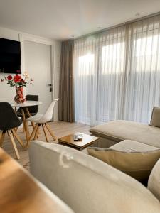 a living room with a couch and a table at Huisje Sille - Private studio in Volendam in Volendam