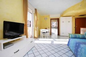 a living room with a flat screen tv on a dresser at WI-RO Risorgimento,9 - La Perla di Andora in Marina di Andora