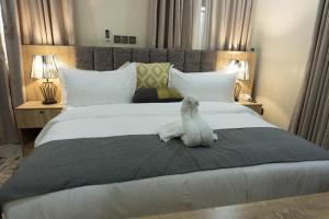 a stuffed animal is sitting on a bed at Stallion Luxury Suites in Ado