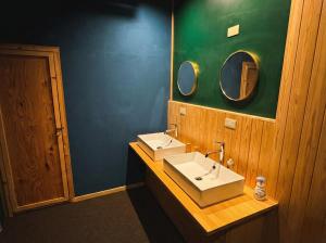 a bathroom with two sinks and a mirror at 山過HOTELs in Chino