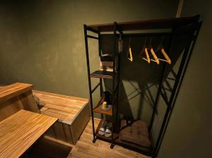 a black shelving unit in a room with wooden floors at 山過HOTELs in Chino