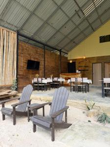 a patio with two chairs and tables and a television at Koh Mook Mountain view in Ko Mook