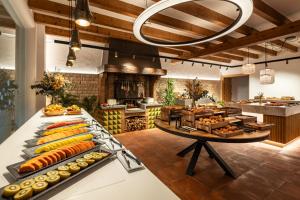 a kitchen with a bunch of food on display at Hotel Cala del Pi - Adults Only in Platja d'Aro