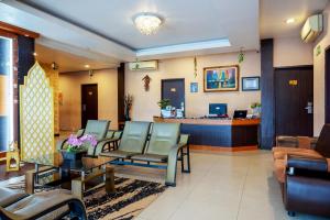 a waiting room at a hospital with chairs and a counter at Tripletree Stefani Hotel in Pekanbaru