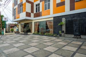 an empty sidewalk in front of a building at Tripletree Stefani Hotel in Pekanbaru