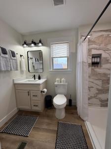 a bathroom with a toilet and a sink and a shower at Sandstone Lodge in Stanton +36 photos