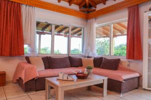 a living room with a couch and a table at VILLA MITZELOS in Skiathos