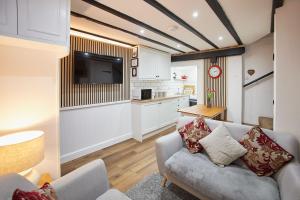 a living room with a couch and a kitchen at Host & Stay - Thimble Cottage in Whitby
