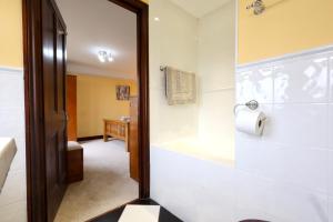 a bathroom with a tub and a toilet paper roll at Great Edge in Luddenden Foot +44 photos