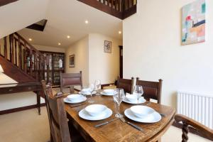 a dining room with a wooden table with wine glasses at Great Edge in Luddenden Foot
