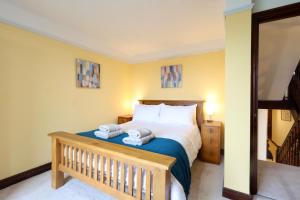 a bedroom with a bed with two towels on it at Great Edge in Luddenden Foot
