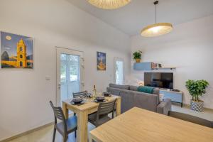 a living room with a table and a couch at Valletta Marina View - Seafront Apartment in Tal-Pietà